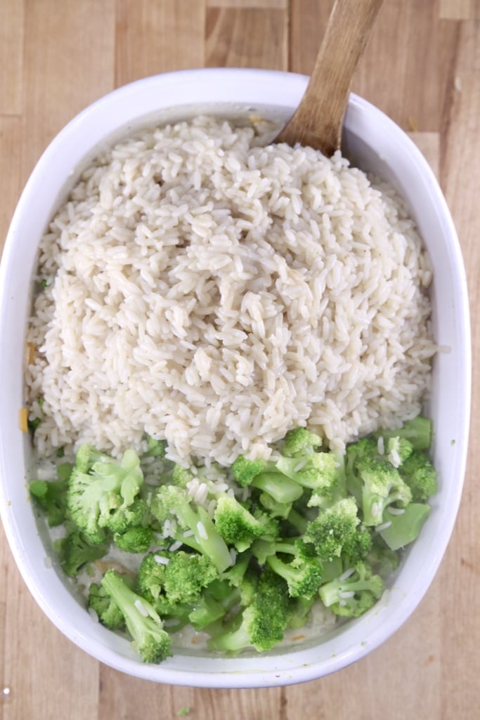 adding rice and steamed broccoli to casserole dish