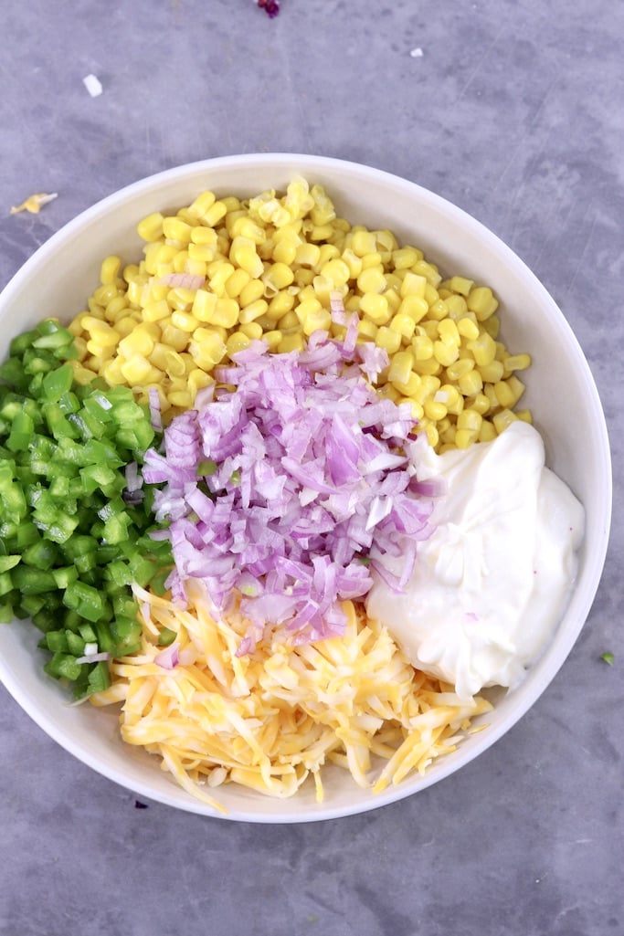 How to make Frito Corn Salad Bowl with corn, red onion, bell pepper, shredded cheese, not mixed