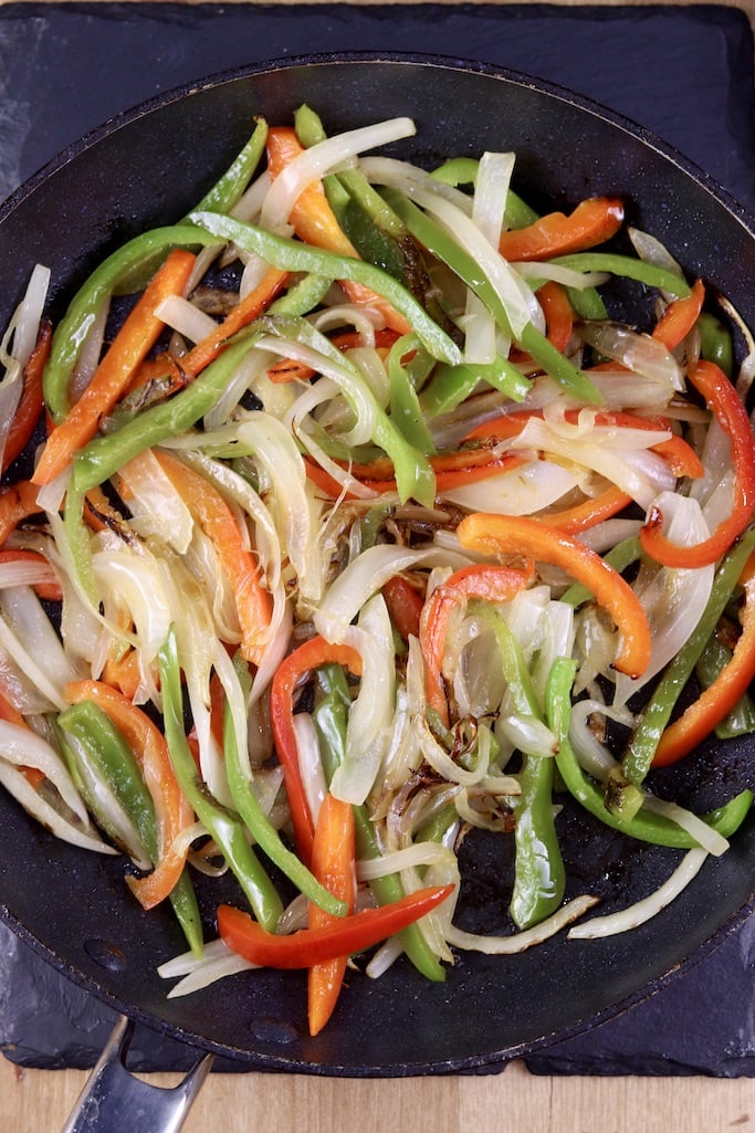 cooked peppers and onions in a skillet