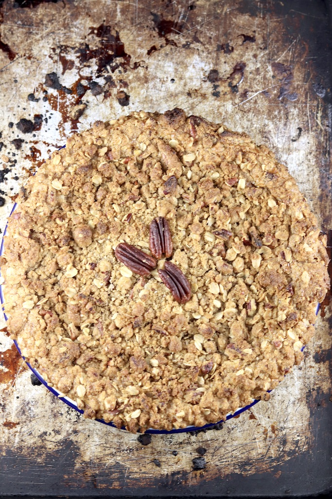 Baked pumpkin pecan crisp on a baking sheet- overhead view