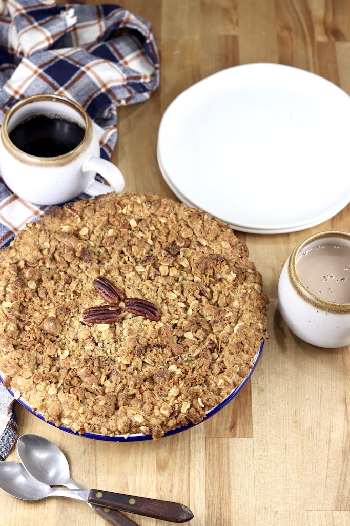 Pumpkin Pecan Crisp with spoons, saucers, and coffee mugs