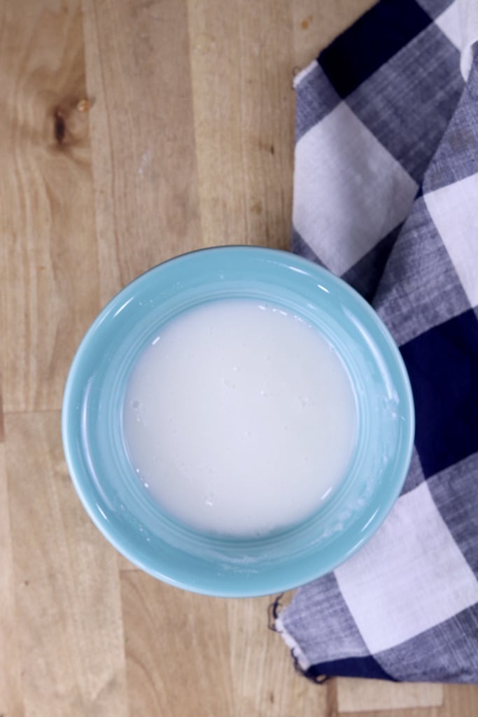 small blue bowl of powdered sugar icing