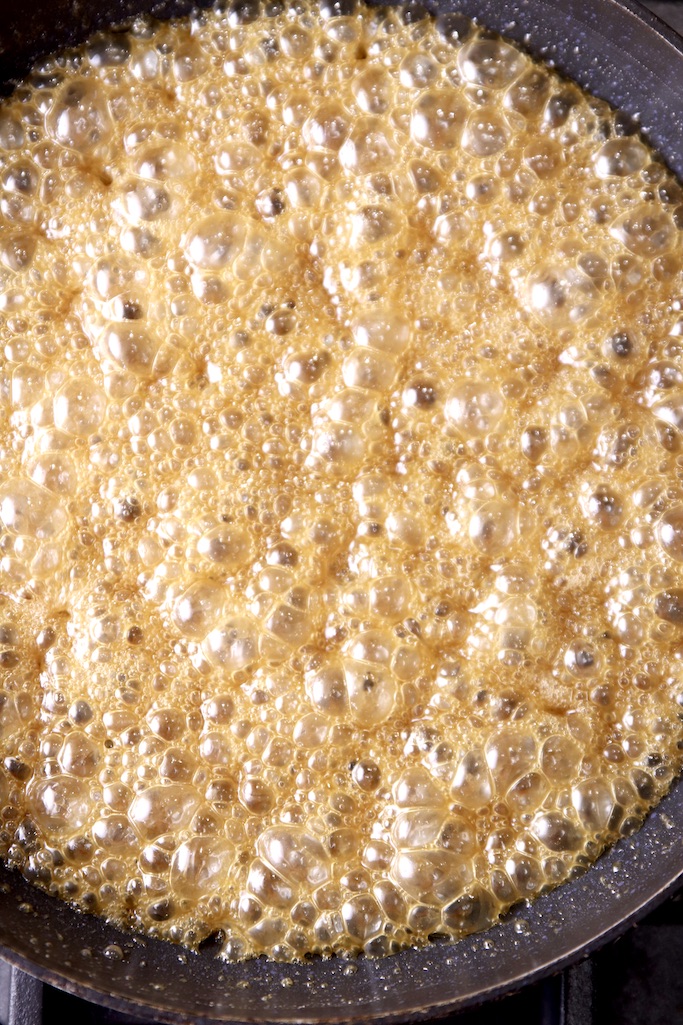 caramelized brown sugar and butter mixture in a skillet for candied walnuts