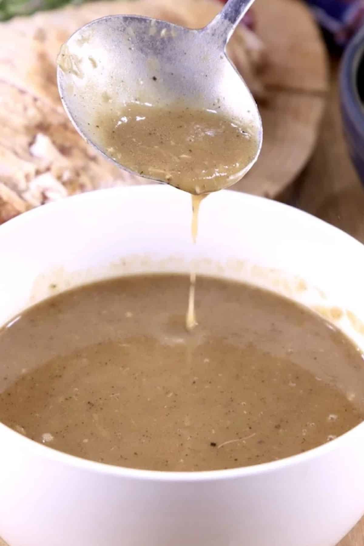 Homemade gravy recipe with or without drippings. Homemade gravy with ladle.