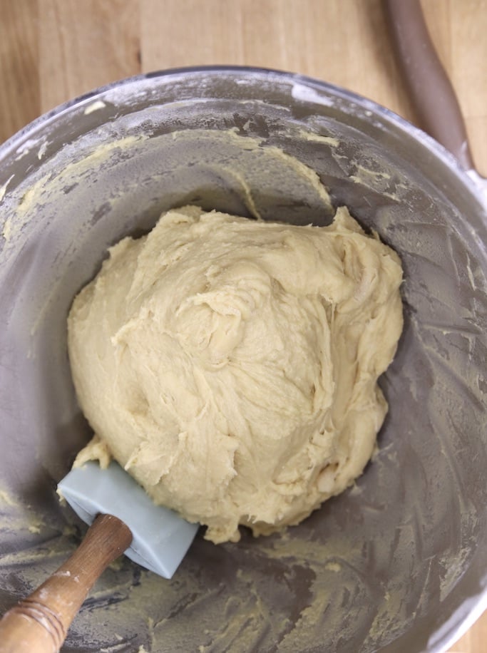Dough ball in mixer bowl with a spatula