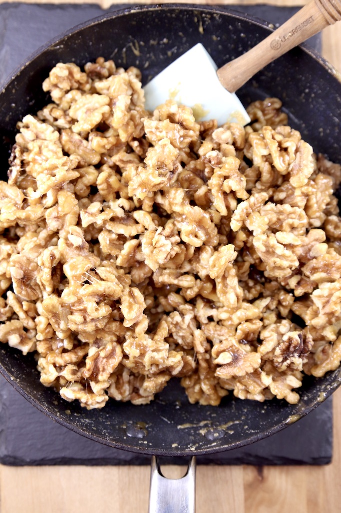 Candied Walnuts in a skillet with a spatula
