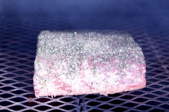 Prime rib with garlic and herbs on a grill 