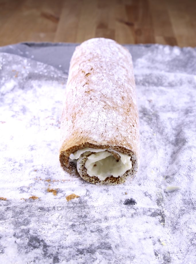 Pumpkin cake roll on a powdered sugar towel