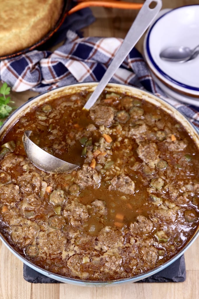 Smoked Sausage Barley Soup in a pan with a ladle