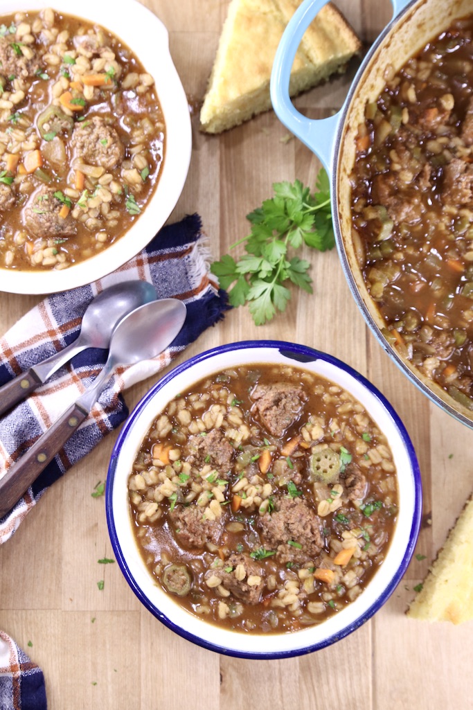 Smoked Sausage Barley Soup win 2 bowls with the soup pan, cornbread slice in between with parsley