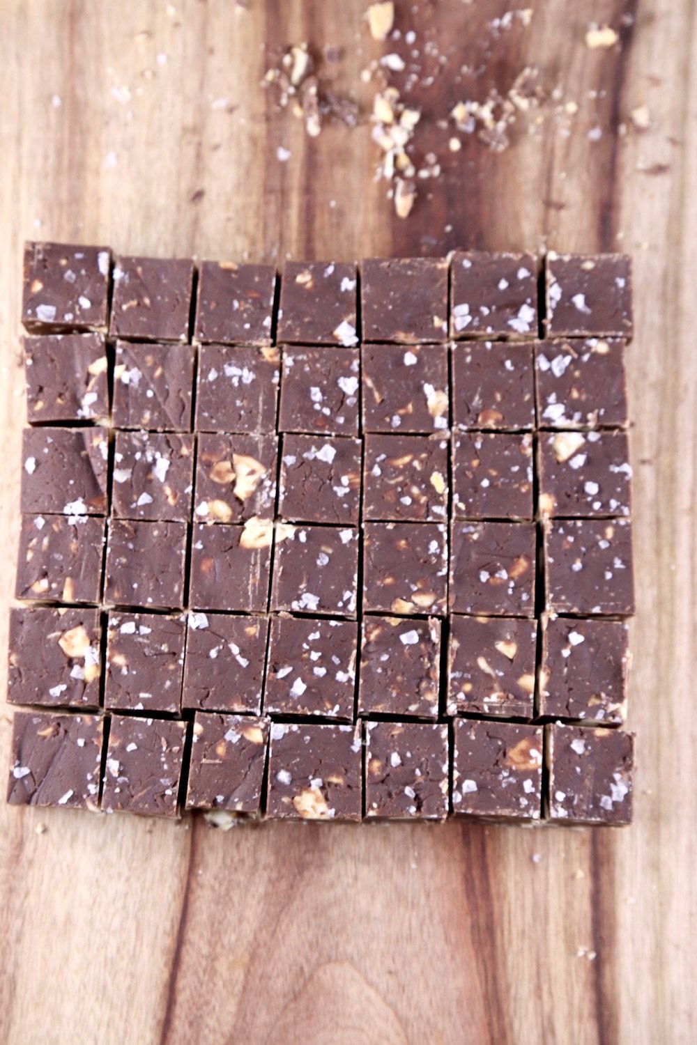 Cutting board with cashew fudge cut into squares
