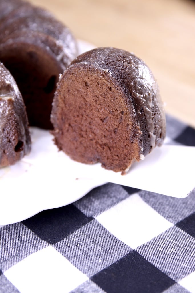 Chocolate Rum Cake is a decadent and delicious dessert for holidays and celebrations but easy enough to make for any day of the week. Chocolate bundt cake soaked in a butter rum sauce. Slice of chocolate rum bundt cake on a cake server