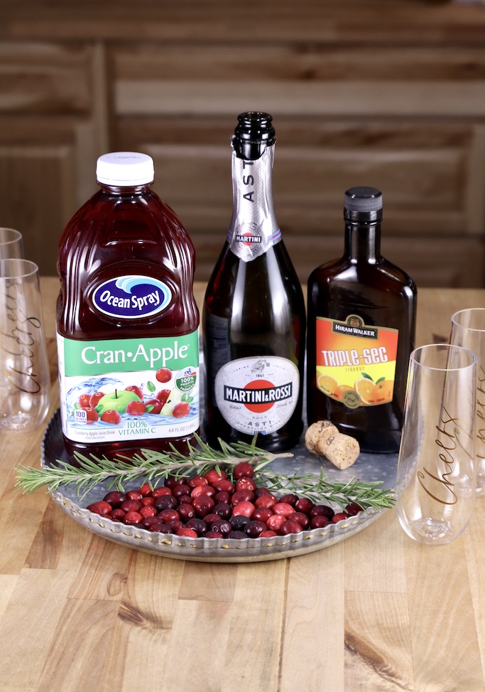 Ingredients for cranberry mimosa cocktails on a tray