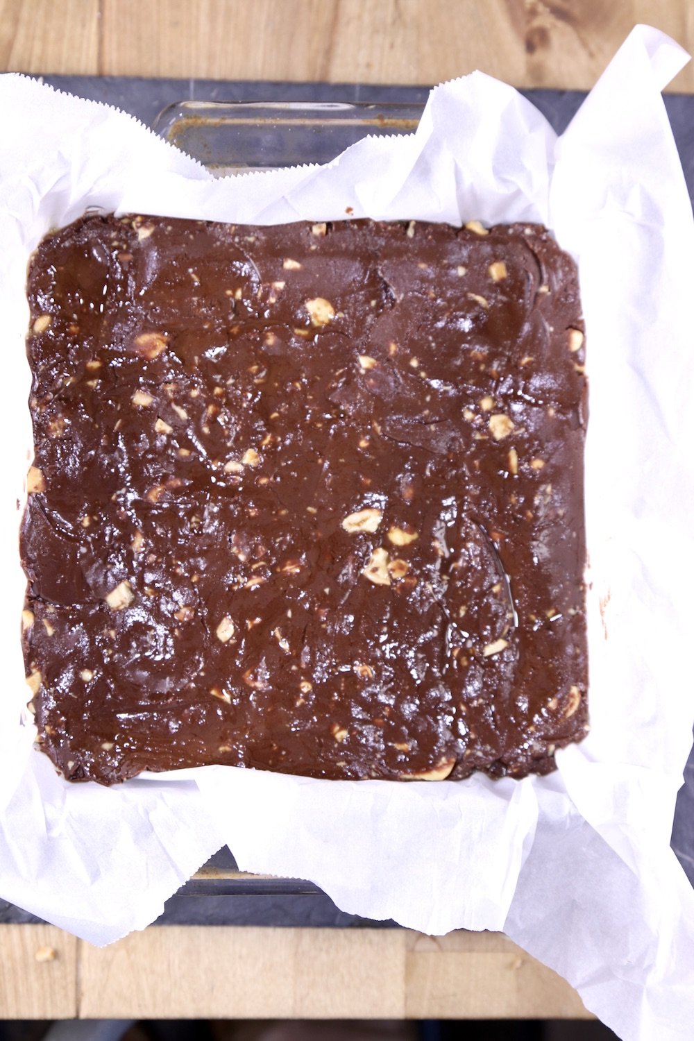 Parchment lined pan with cashew fudge before chilling