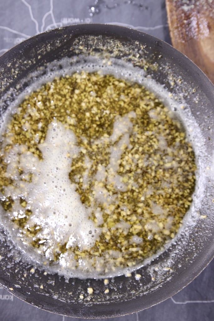 skillet of butter with toasted garlic and rosemary