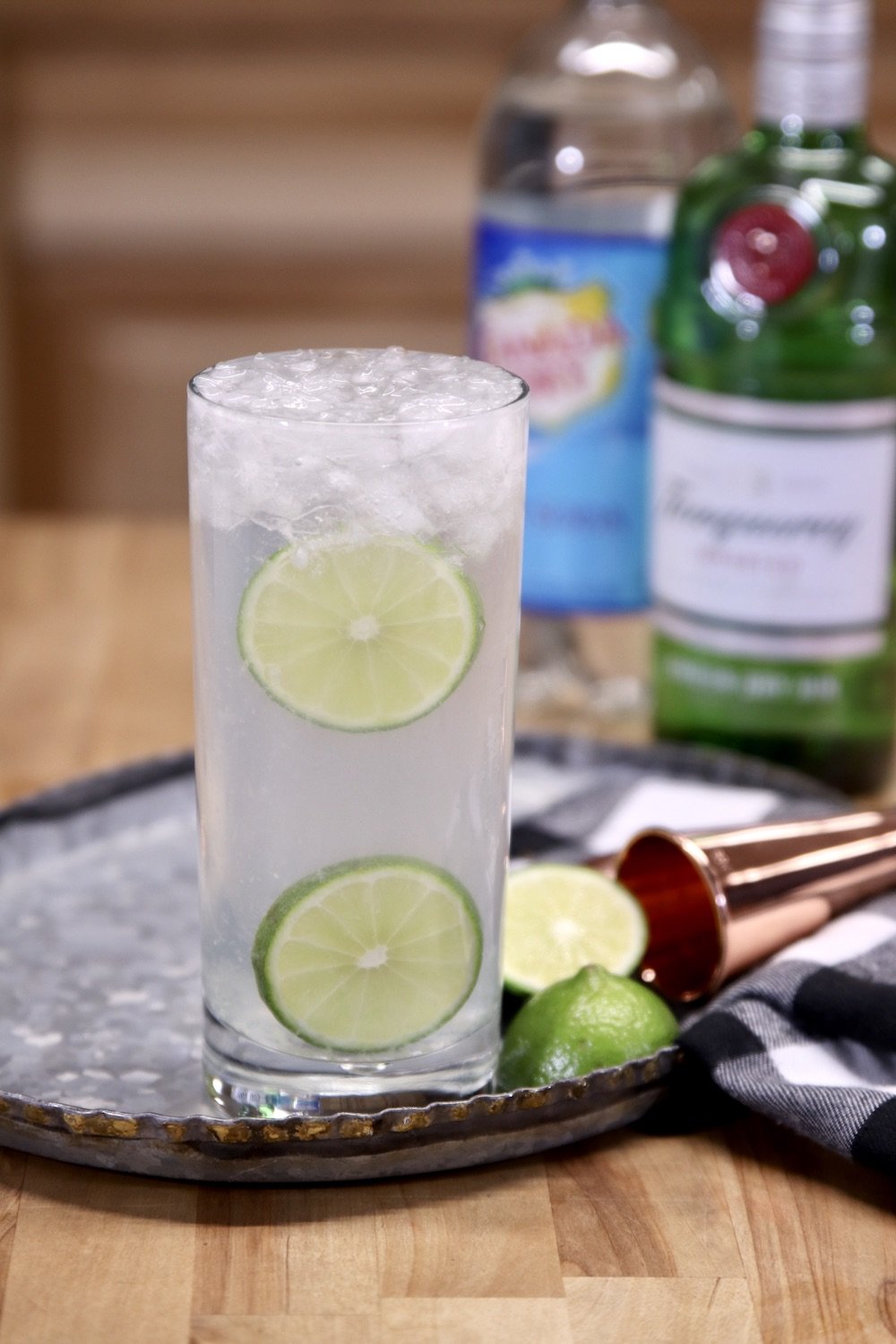 Gin Rickey Cocktail with gin and club soda in background