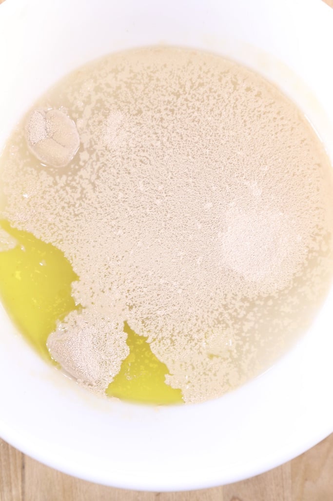 bowl with water, yeast, sugar and olive oil