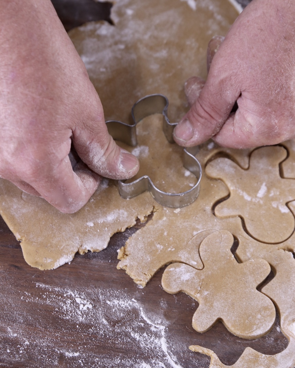 Cutting out gingerbread cookie dough