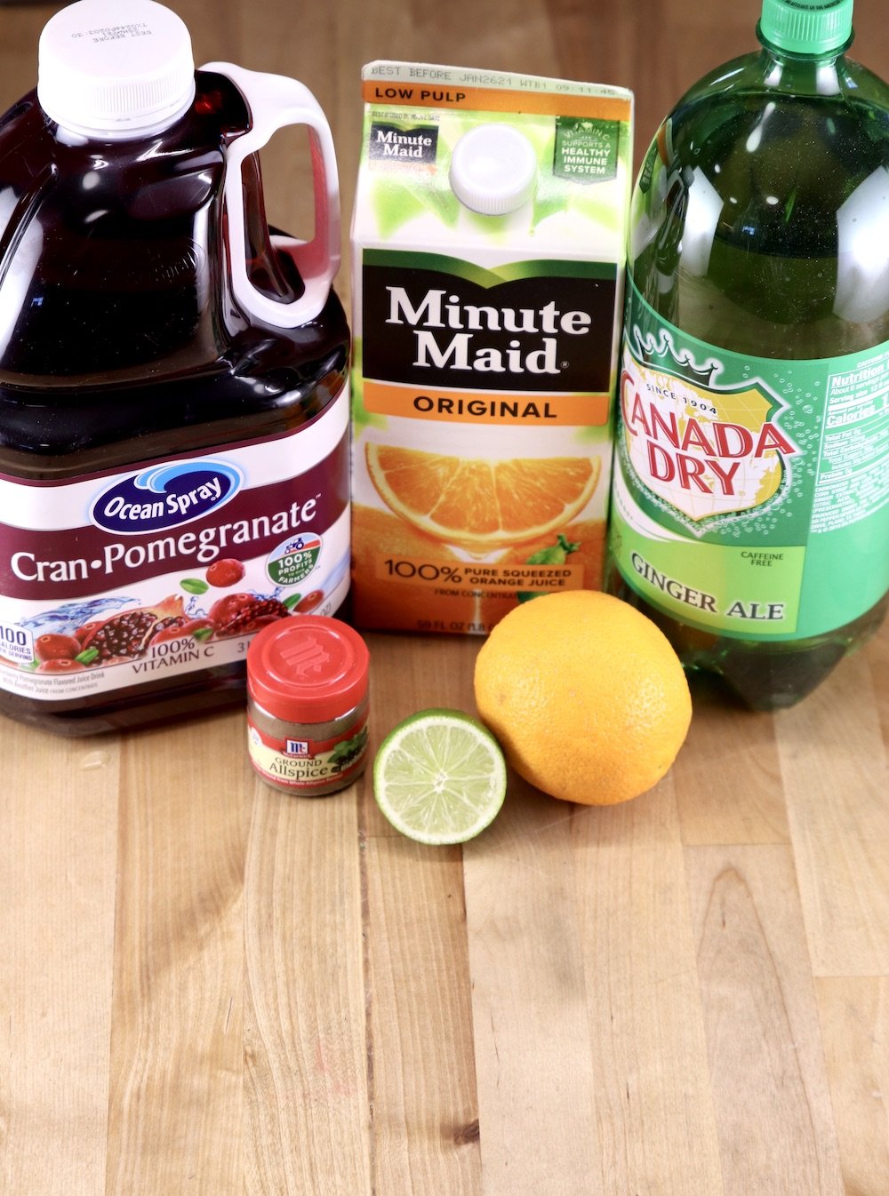 ingredients for Christmas Punch: Cranberry Juice, Orange Juice, Ginger Ale, Allspice, Orange, Lime