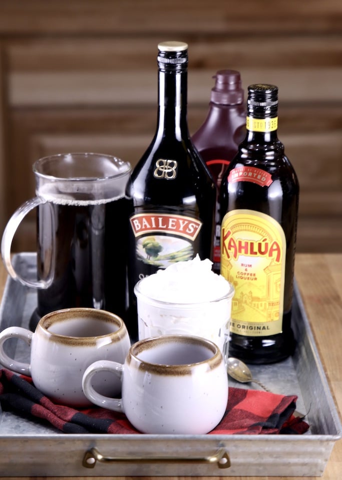 Ingredients for Mudslide coffee on a tray with 2 mugs