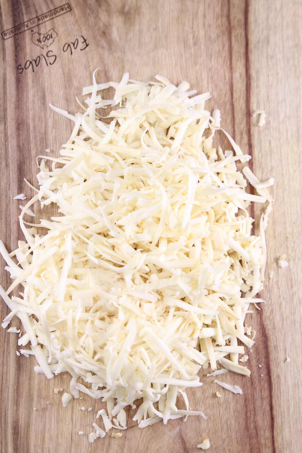 Shredded cheese on a cutting board