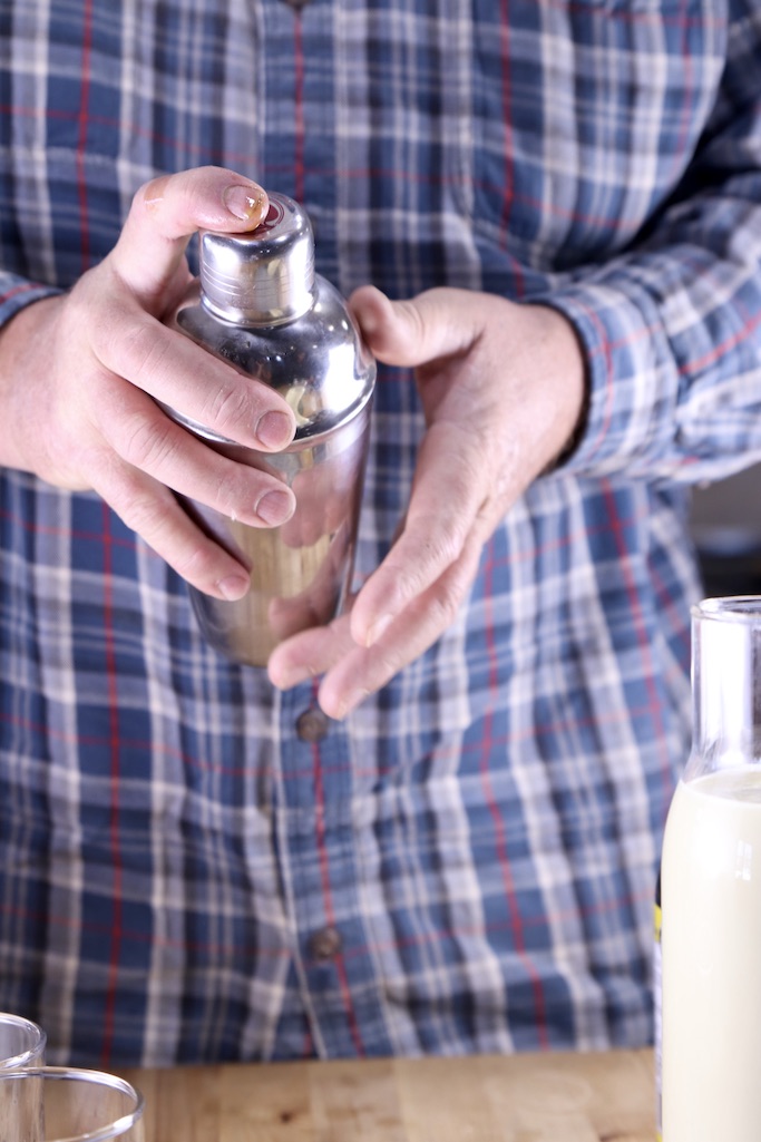Man shaking a cocktail shaker 