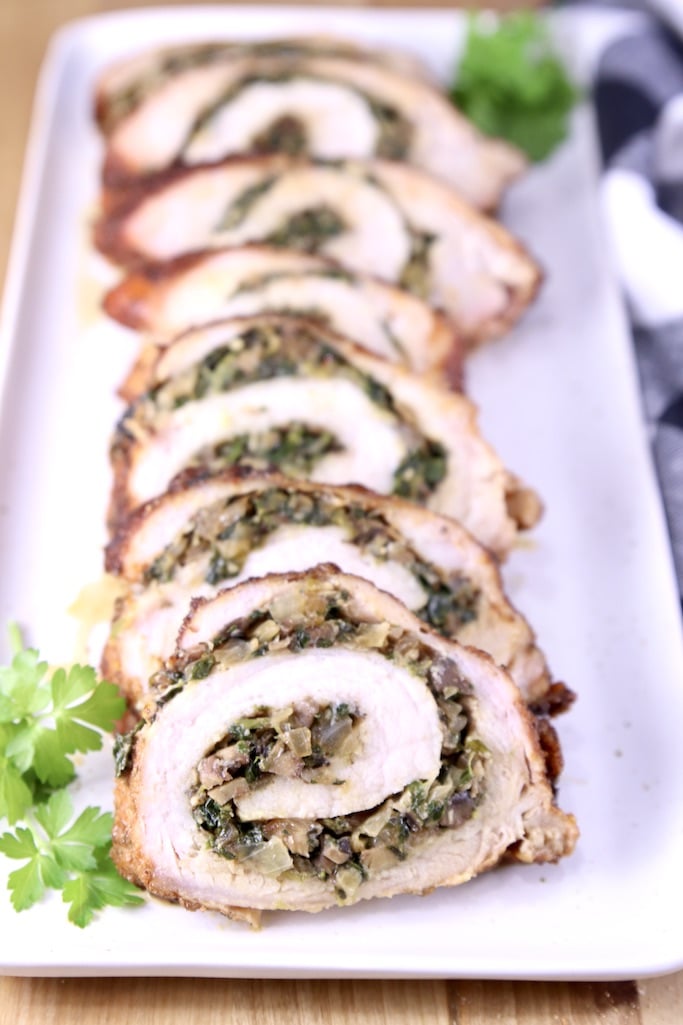 Stuffed Pork Tenderloin on a platter, closeup view of slices