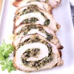 Sliced stuffed pork tenderloin on a platter