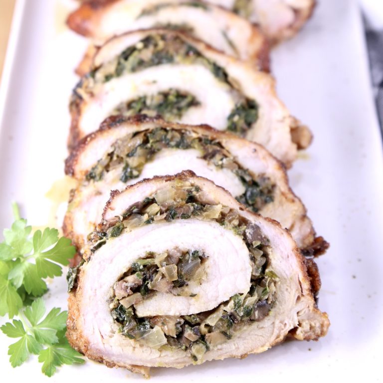 Sliced stuffed pork tenderloin on a platter