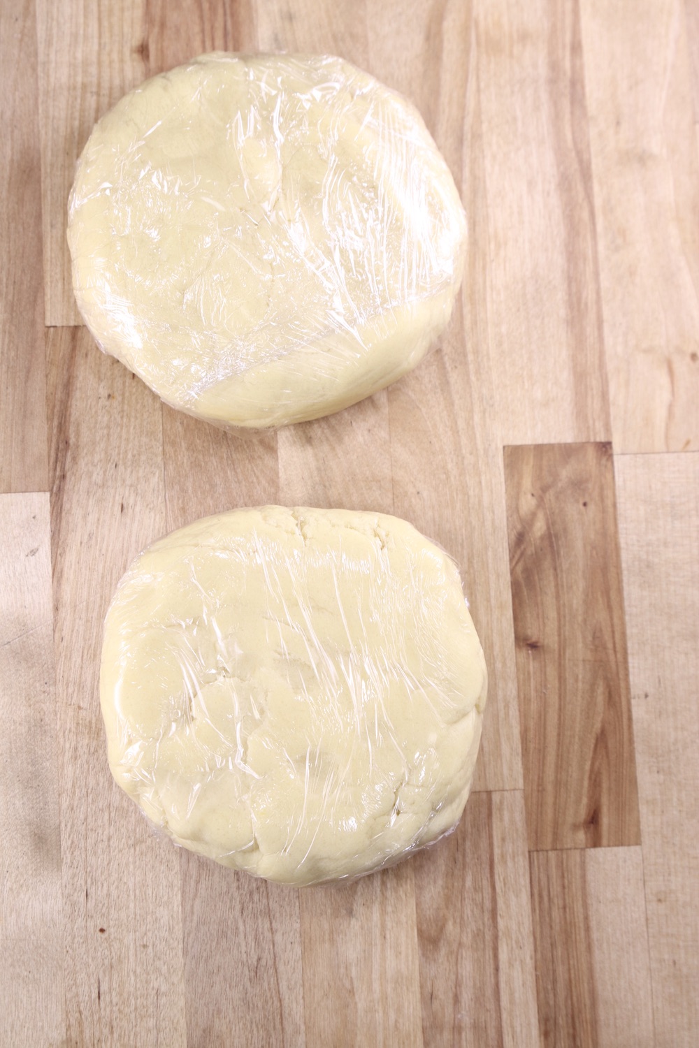 2 rounds of sugar cookie dough wrapped in plastic wrap