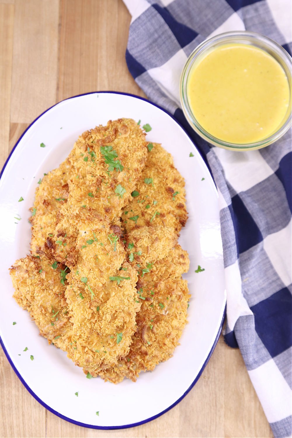 Platter of cornflake chicken tenders with honey mustard sauce on the side