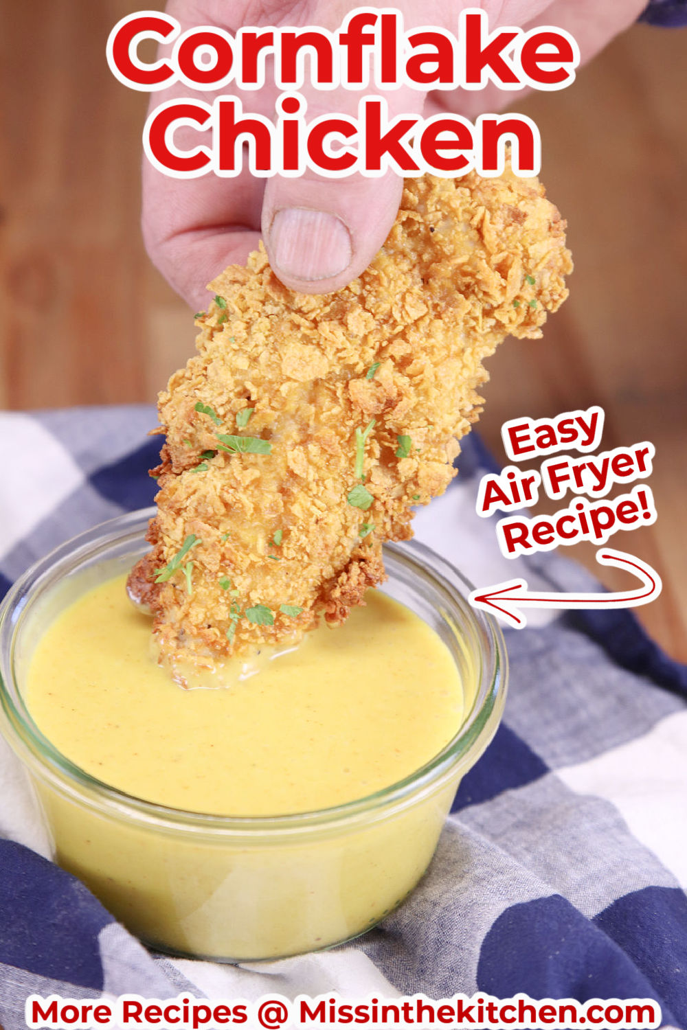 chicken tender breaded with cornflakes dipping in honey mustard with text overlay