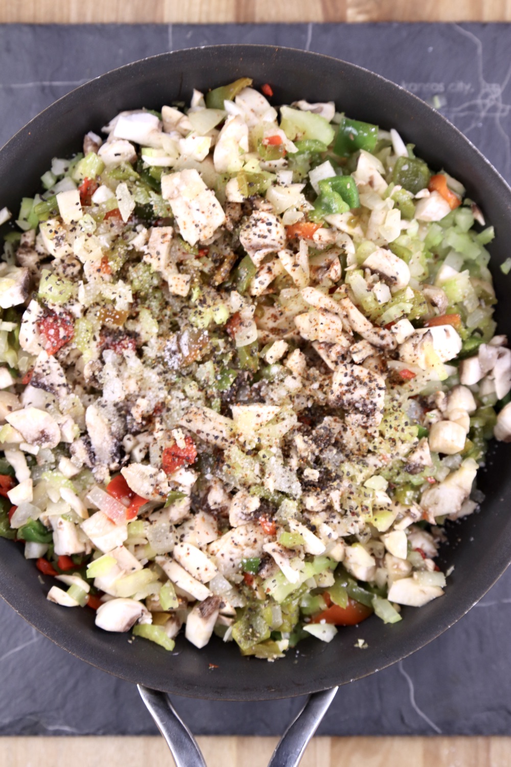 cooked mushrooms, onions, celery and bell peppers in a skillet