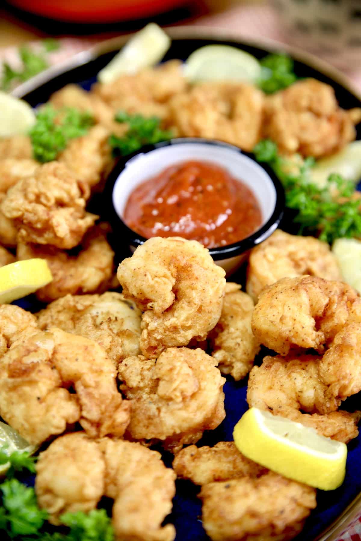 Platter of shrimp with cocktail sauce.
