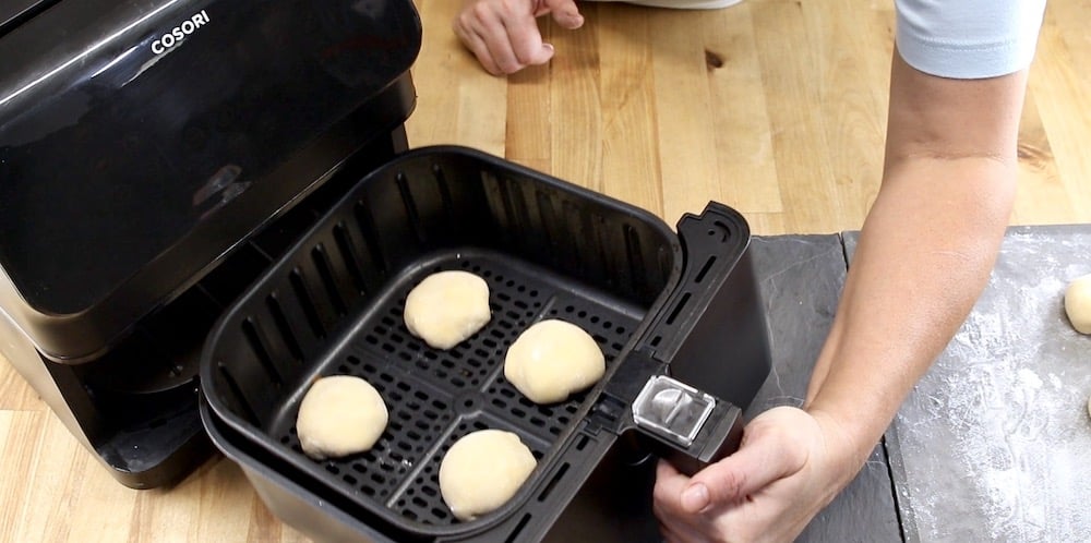 Cooking peach cobbler bombs in an air fryer basket