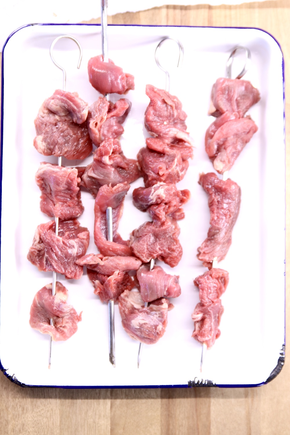 steak skewers on a white tray