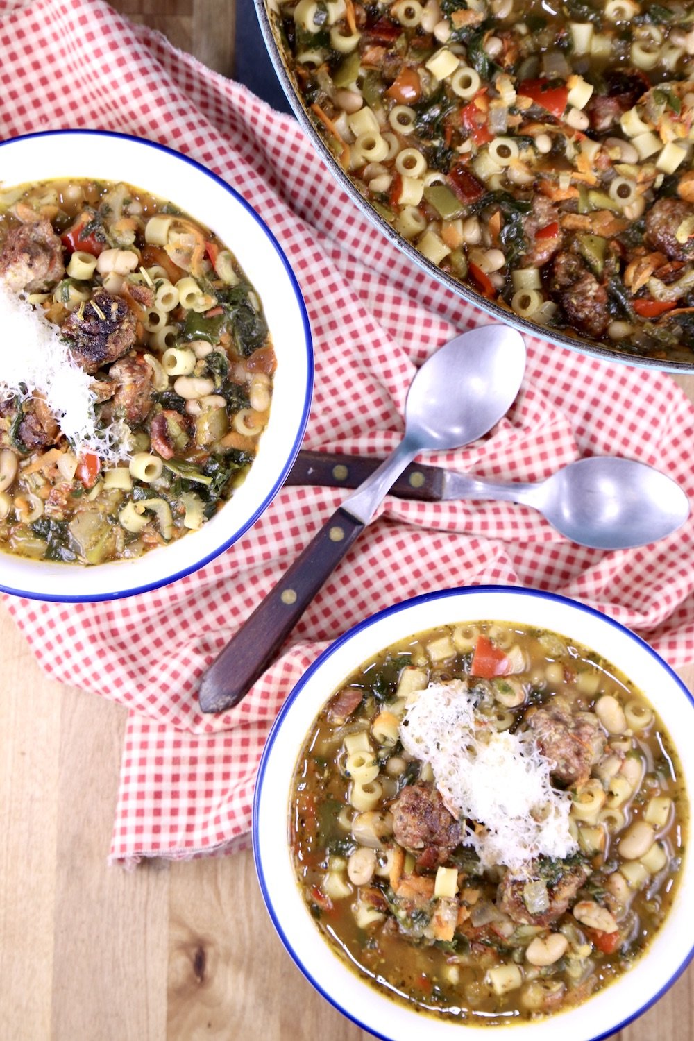 Meatball Soup in 2 bowls with spoons, red check napkin