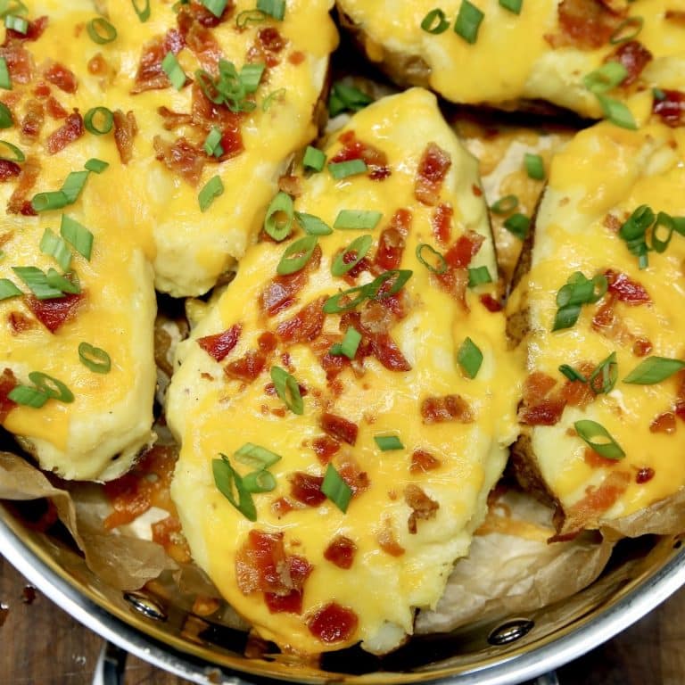 Potatoes topped with cheesy filling and bacon.