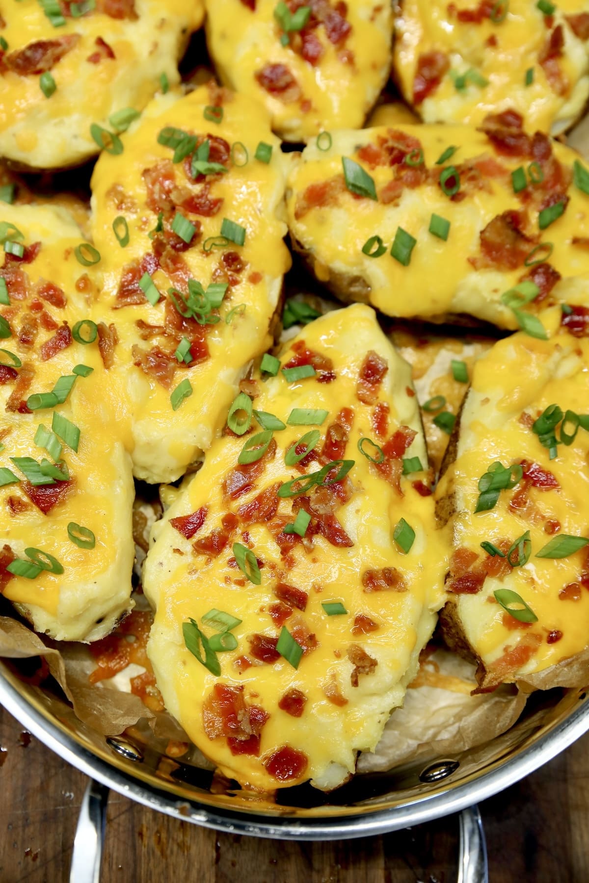 Pan of twice baked potatoes with bacon and green onions.