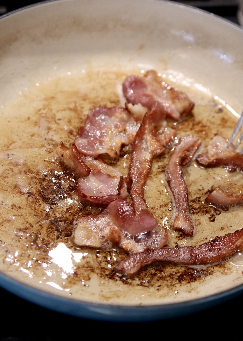 bacon frying in a pan