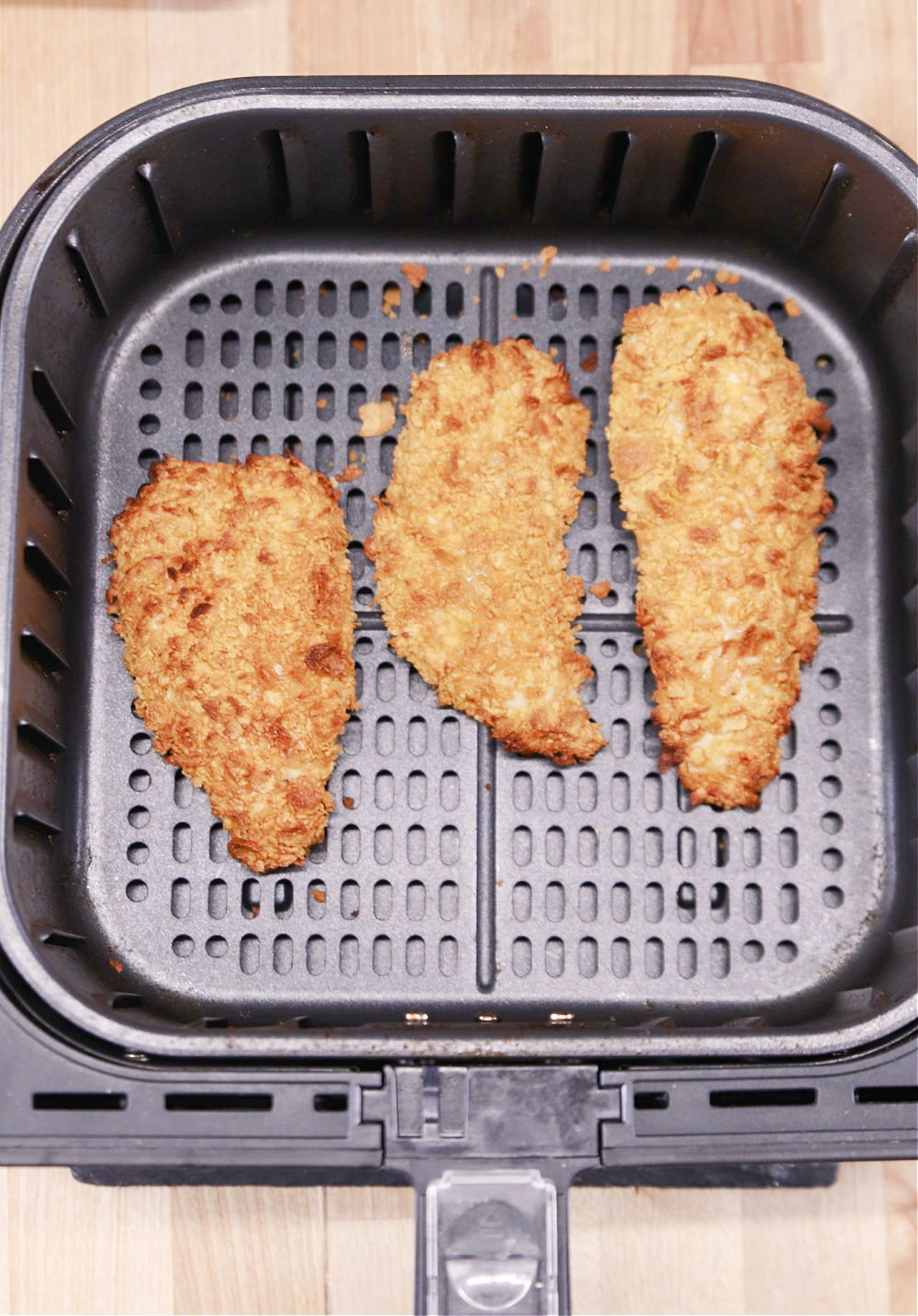 crispy cornflake chicken strips in air fryer basket