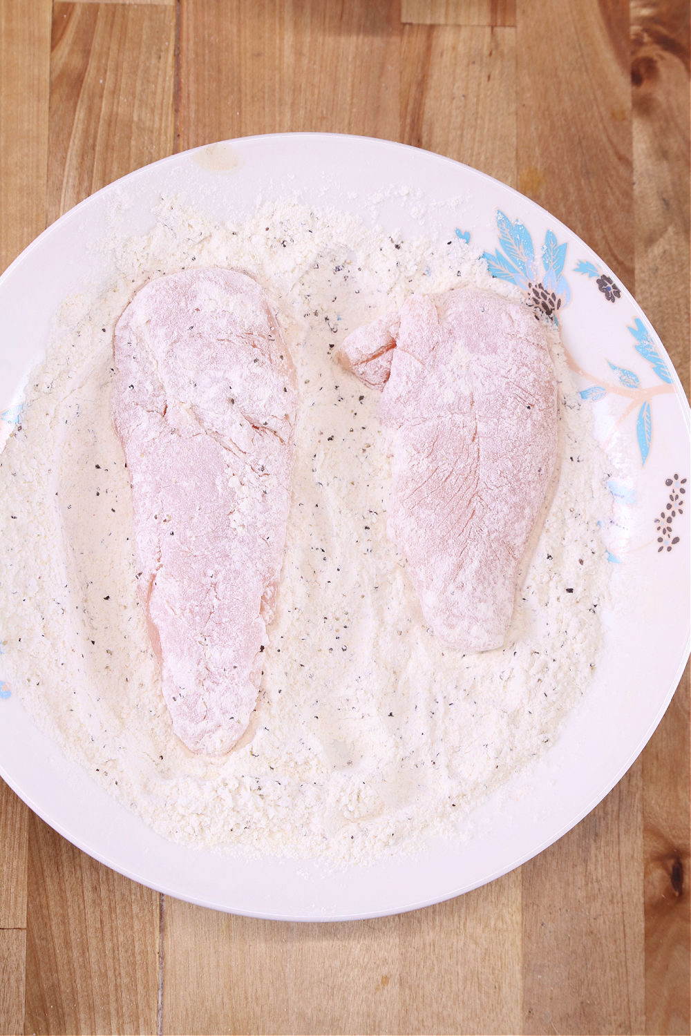 bowl of flour coated chicken tenders