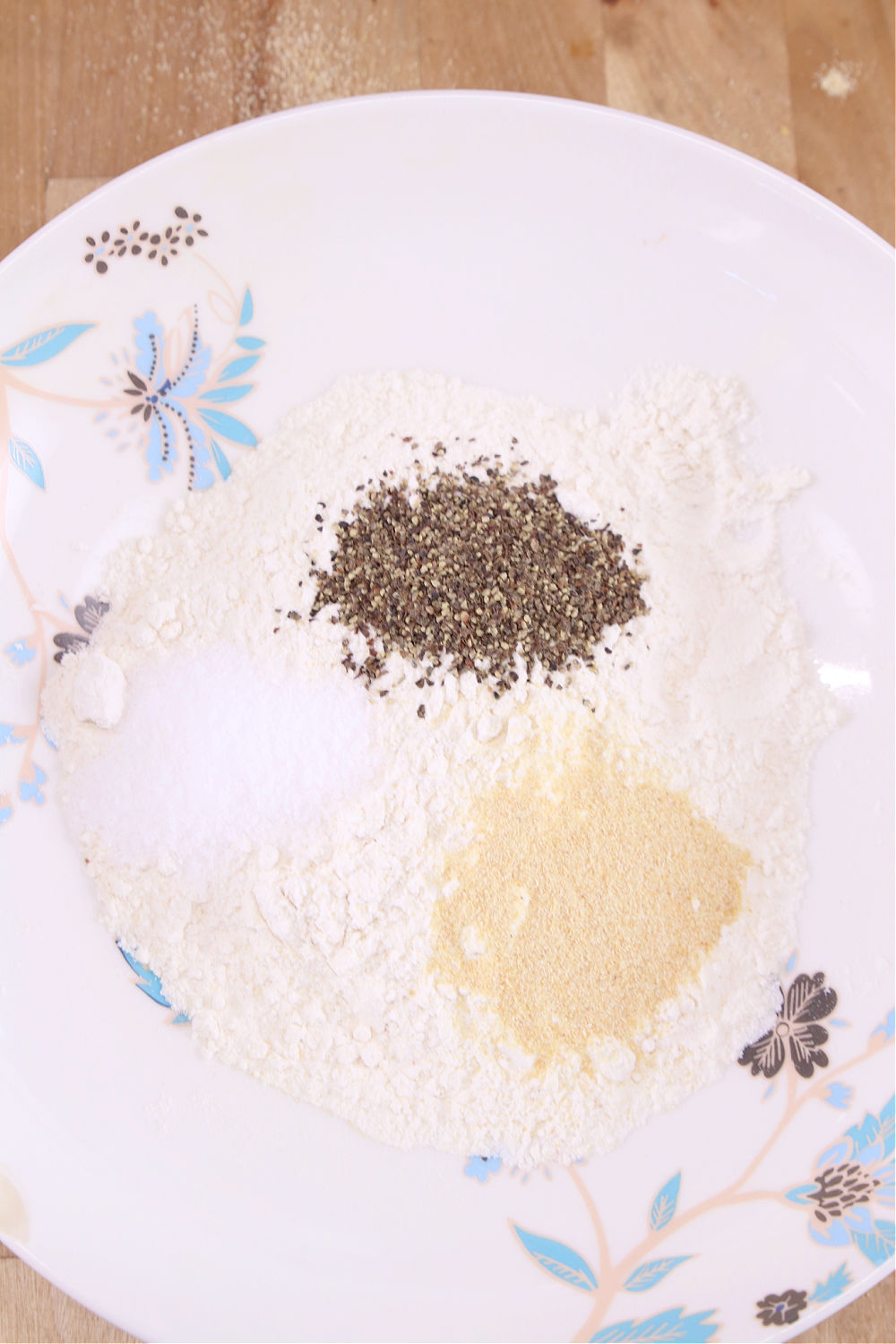 Bowl with flour, salt, pepper and garlic for breading chicken
