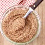 Jar of homemade chili seasoning with a spoon