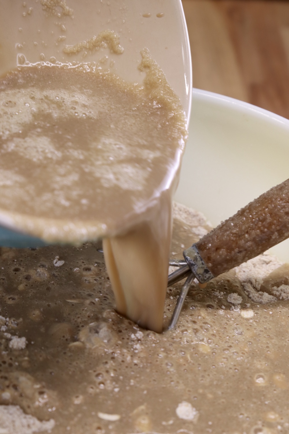 pouring wet ingredients into dry for brown bread
