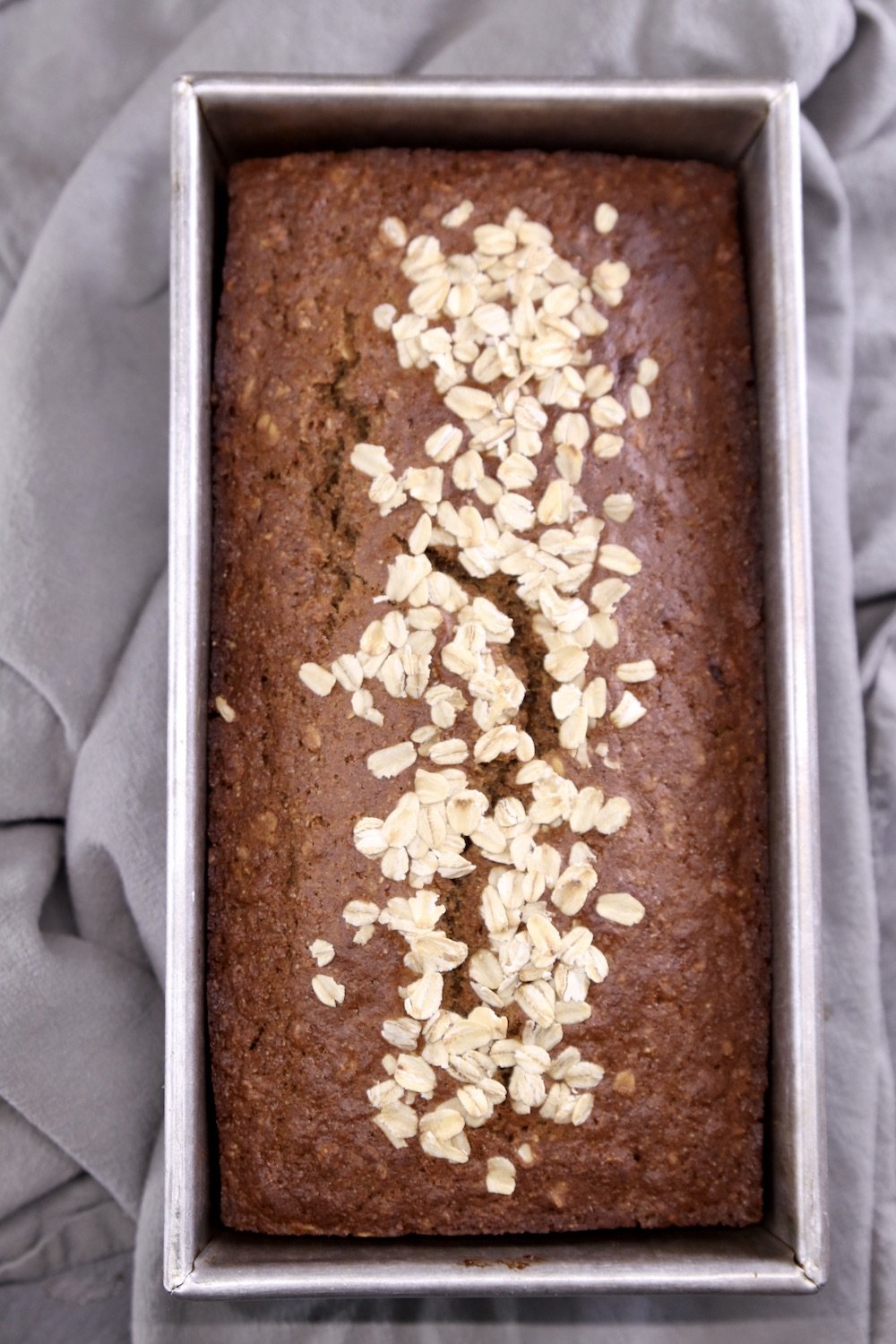 Loaf pan with baked Irish Brown Bread with oat topping