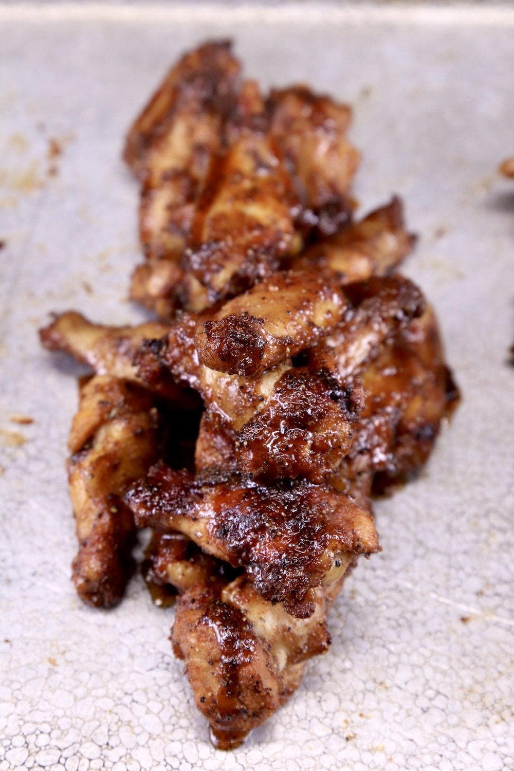 chicken wings with maple glaze on a baking sheet