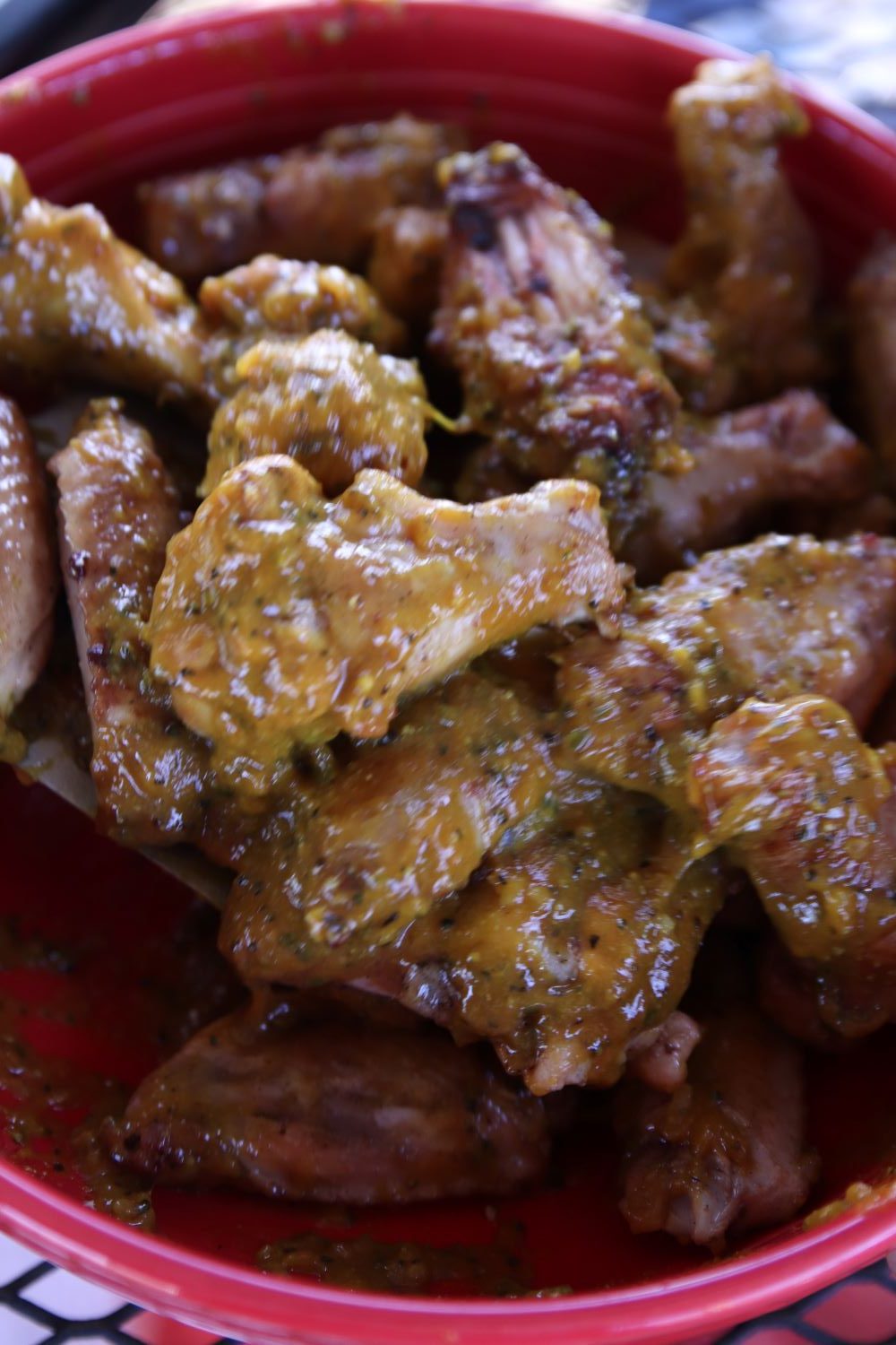 Bowl of mustard coated chicken wings