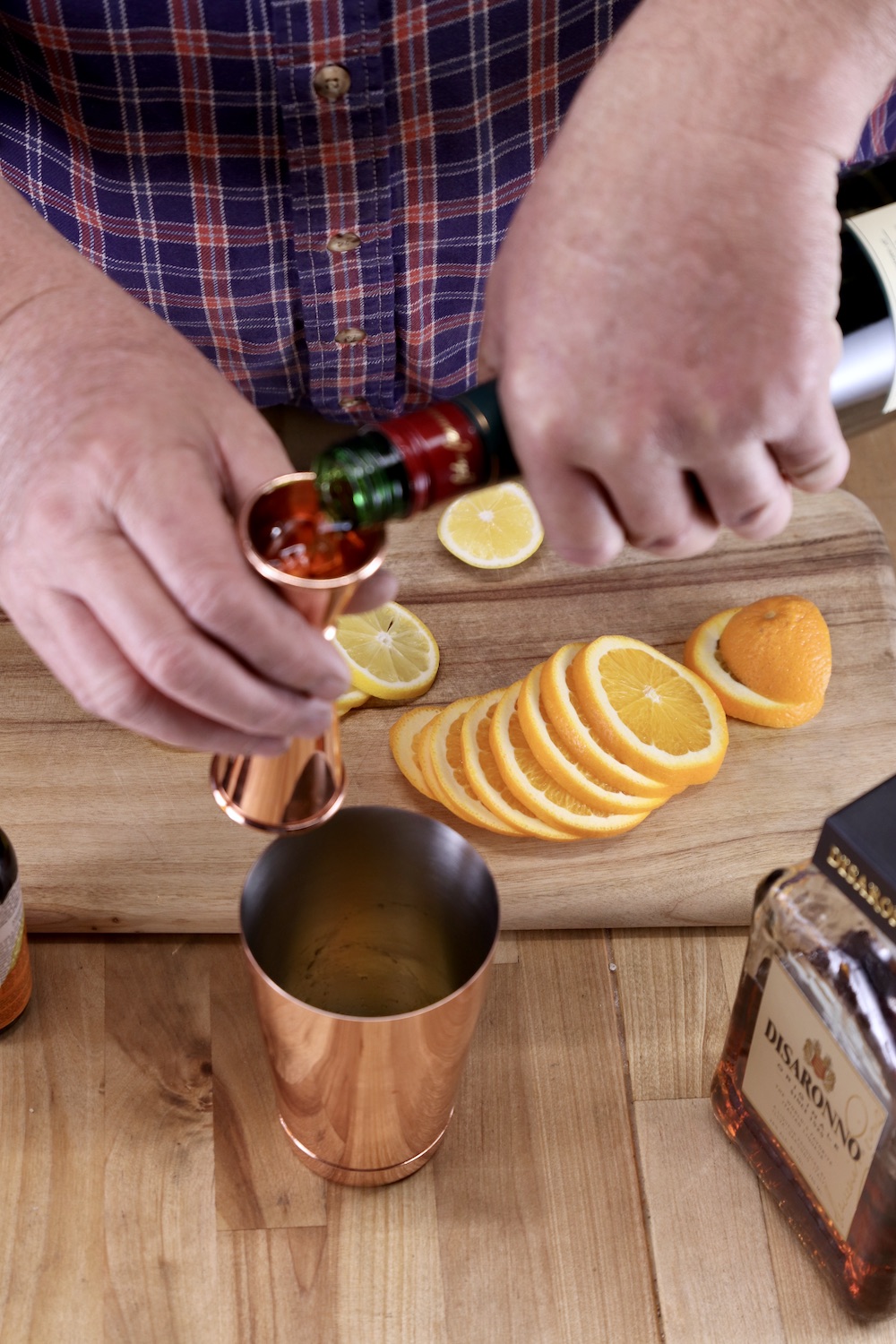 pouring whiskey into a jigger