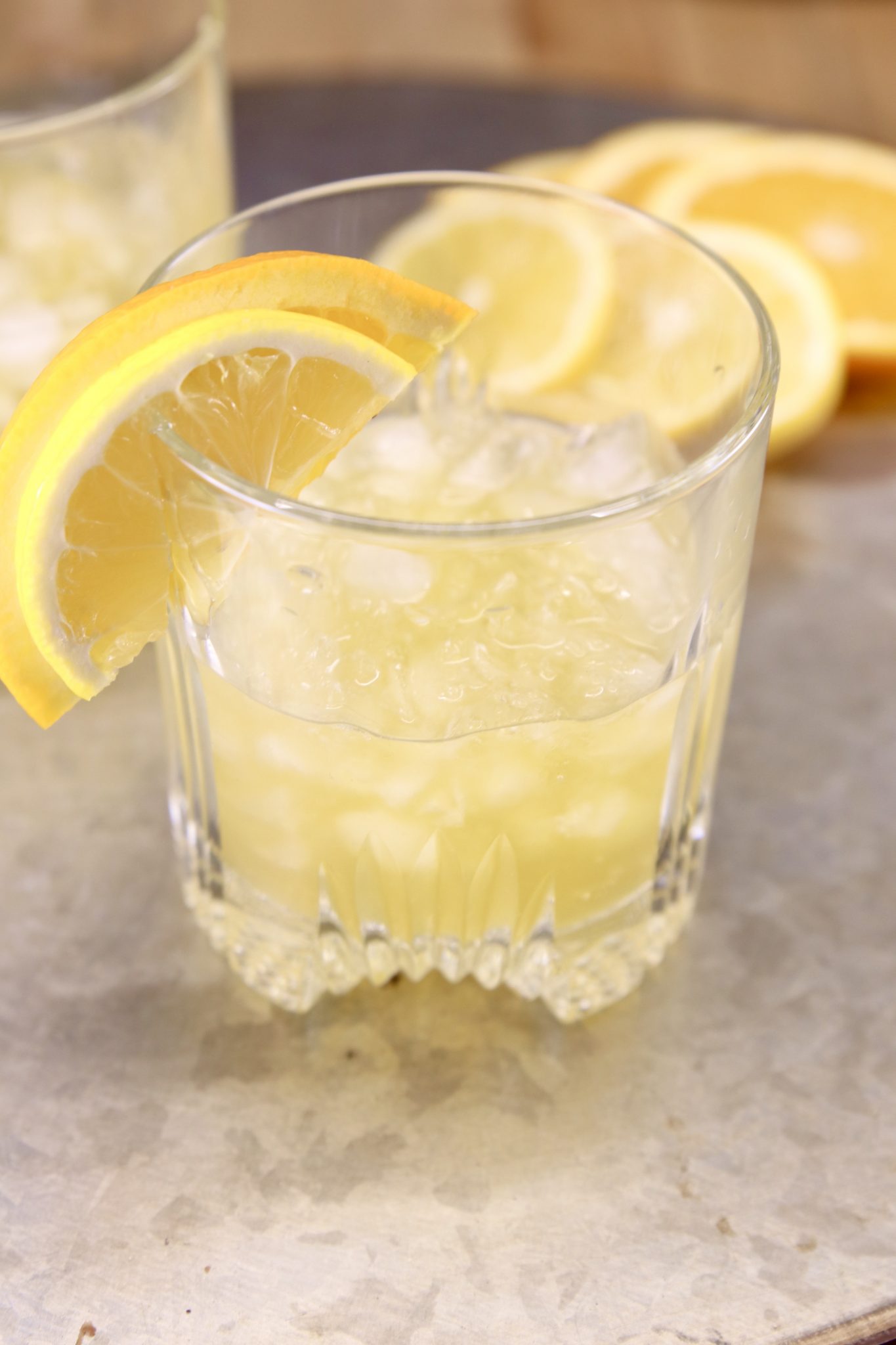 Amaretto Whiskey Sour cocktail garnished with lemon and orange slice